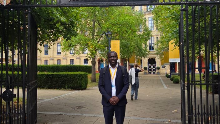 Stephen Amponsah in front of the Cambridge Judge gates.