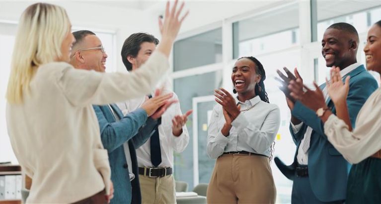 Colleagues celebrating in an office.