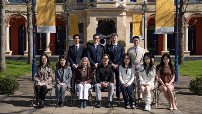 Class photo with 9 MPhil in SMOOB students, the programme director, and the programme administrator.